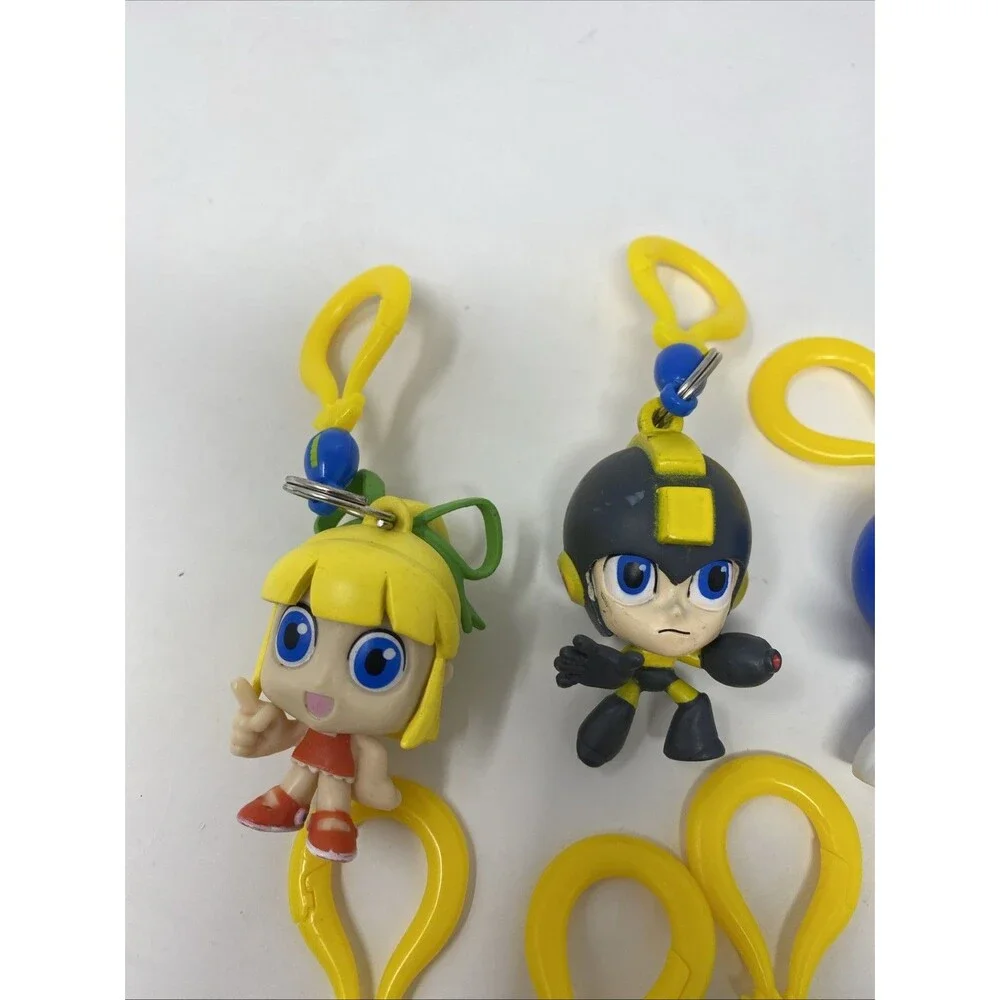 lot of 9 CAPCOM MEGA MAN BACKPACK HANGERS METALLIC FIRE MAN JUST TOYS INTL.